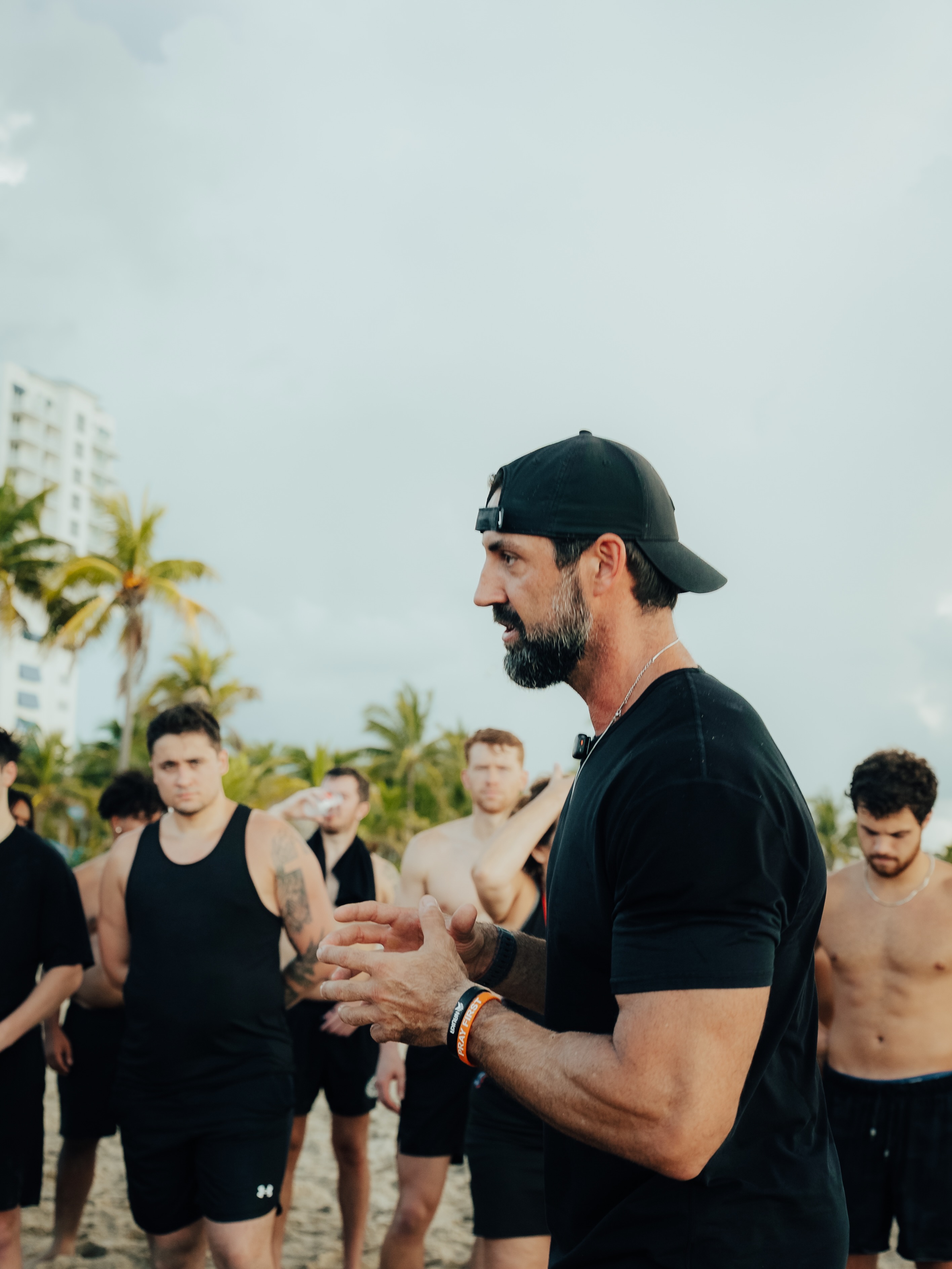 Team straining on a rope pull on the beach